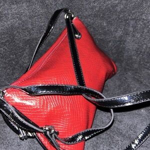 Leather with a snake skin look with a big buckle on the front